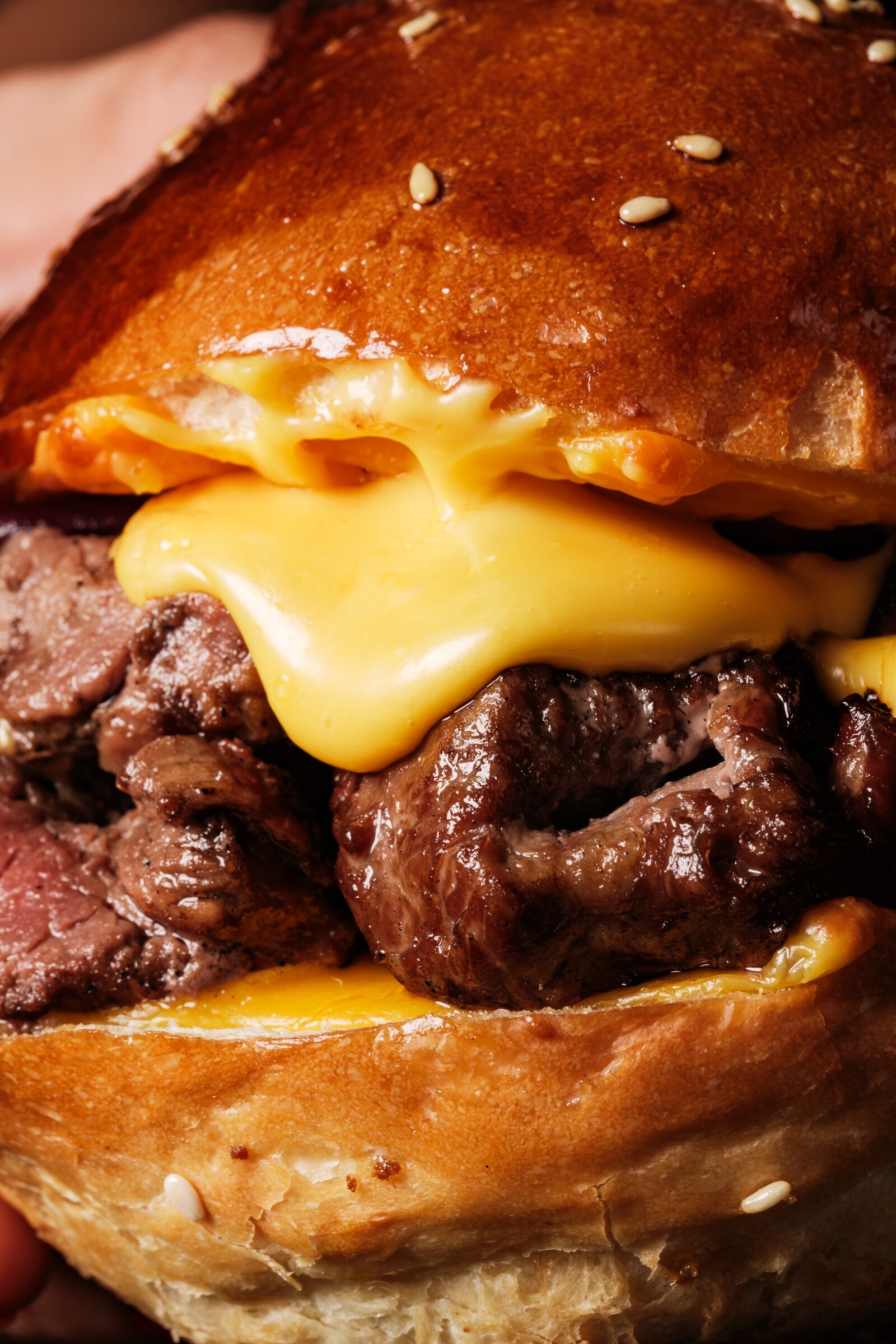 Close up of a burger with melted cheese